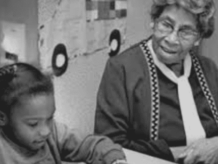 A Citizenship School teacher working with a young student